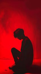 Thoughtful Grief: Free Sad Boy 4K Wallpaper for Lock Screen